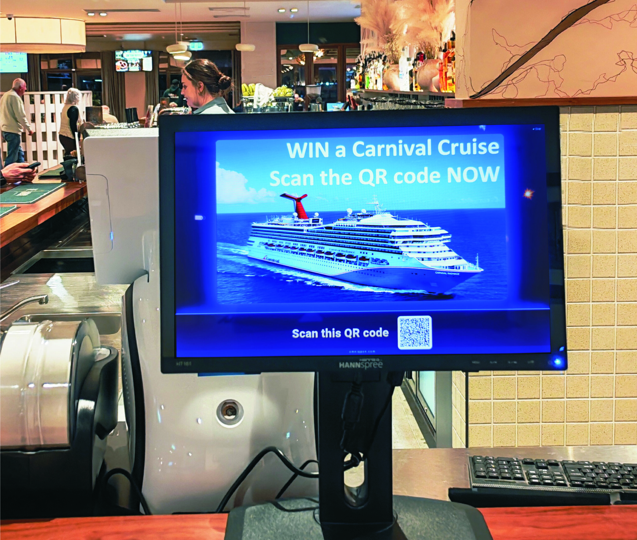 In-venue screen promoting a prize draw with a scannable QR code